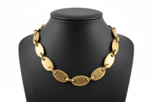 Load image into Gallery viewer, a necklace of BRASS on a black faux leather jewelry display bust with a white background