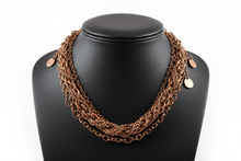 Load image into Gallery viewer, a necklace of COPPER chains on a black faux leather jewelry display bust with a white background