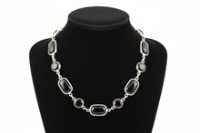 Load image into Gallery viewer, a necklace of silver chains with black colored STONES on a black jewelry display bust with a white background