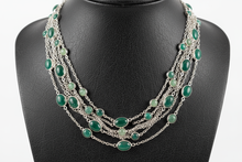 Load image into Gallery viewer, a necklace of silver chains with GREEN colored STONES on a black faux leather jewelry display bust with a white background