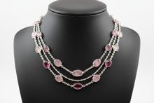 Load image into Gallery viewer, a necklace of silver chains with PINK colored STONES on a black faux leather jewelry display bust with a white background