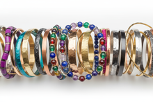 Load image into Gallery viewer, multiple, multicolored bracelets, consisting of elastic, cuff and bangle styles, clustered together