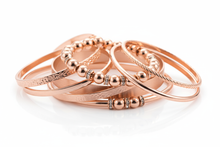 Load image into Gallery viewer, rose gold colored bracelets, consisting of elastic, cuff and bangle styles, clustered together with a white background