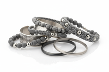 Load image into Gallery viewer, shades of gray bracelets, consisting of elastic, cuff and bangle styles, clustered together with a white background