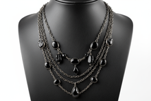 Load image into Gallery viewer, a necklace of silver chains with black colored STONES on a black faux leather jewelry display bust with a white background
