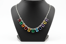 Load image into Gallery viewer, a necklace of silver chains with RAINBOW colored STONES on a black faux leather jewelry display bust with a white background
