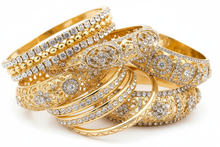 Load image into Gallery viewer, gold and bling bracelets, consisting of elastic, cuff and bangle styles, clustered together with a white background

