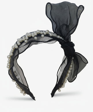 Black headband with sheer fabric and pearls on a white background