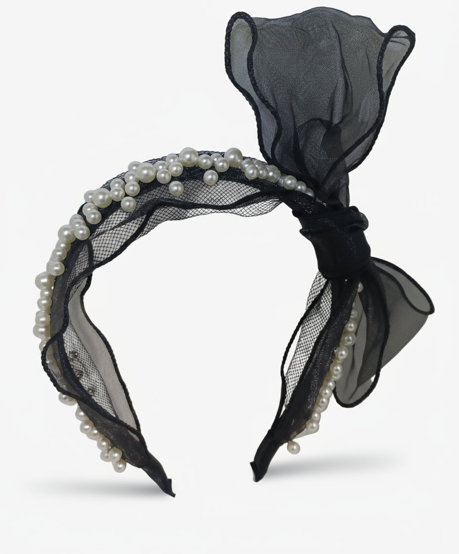 Black headband with sheer fabric and pearls on a white background
