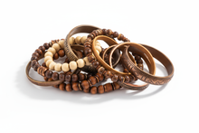 Load image into Gallery viewer, shades of brown bracelets, consisting of elastic, cuff and bangle styles, clustered together with a white background
